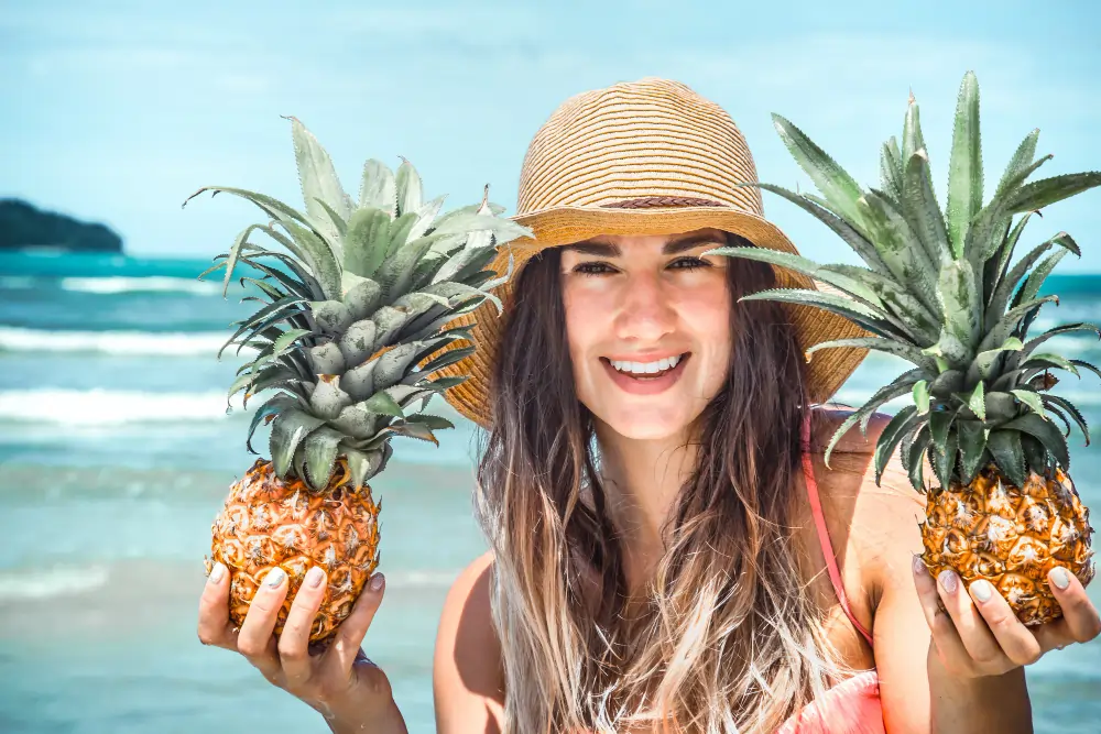 beautiful women holding pineapple summer fruits